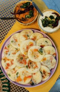 Delicious South Indian idli served with spicy coconut and tomato chutney, showcasing traditional flavors.